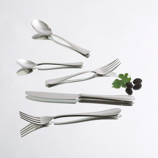 A group of Arcoroc stainless steel salad/dessert forks on a white surface.