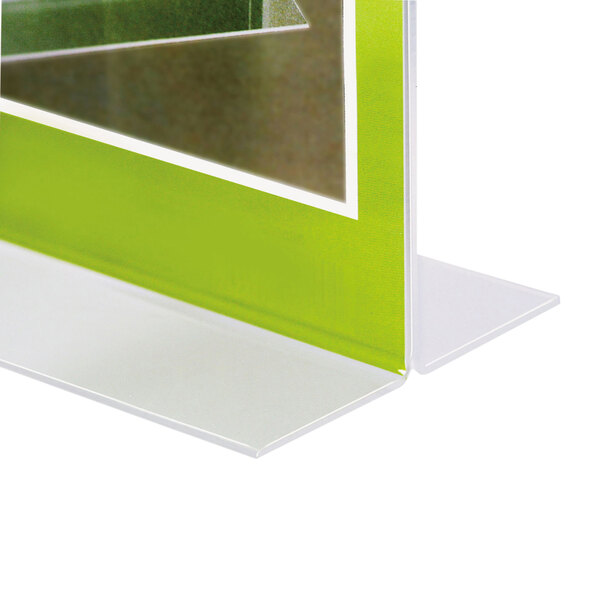 A close-up of a clear plastic NuDell double-sided sign holder on a table.