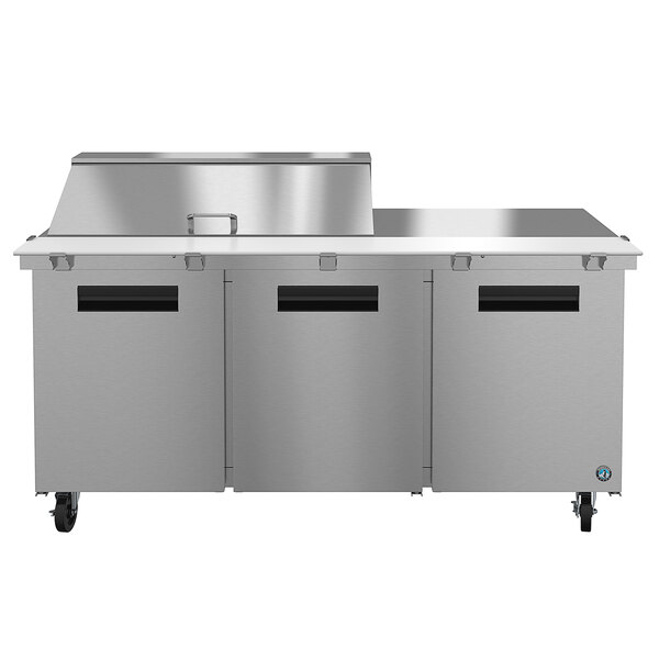 A Hoshizaki stainless steel refrigerated sandwich prep table with three doors.