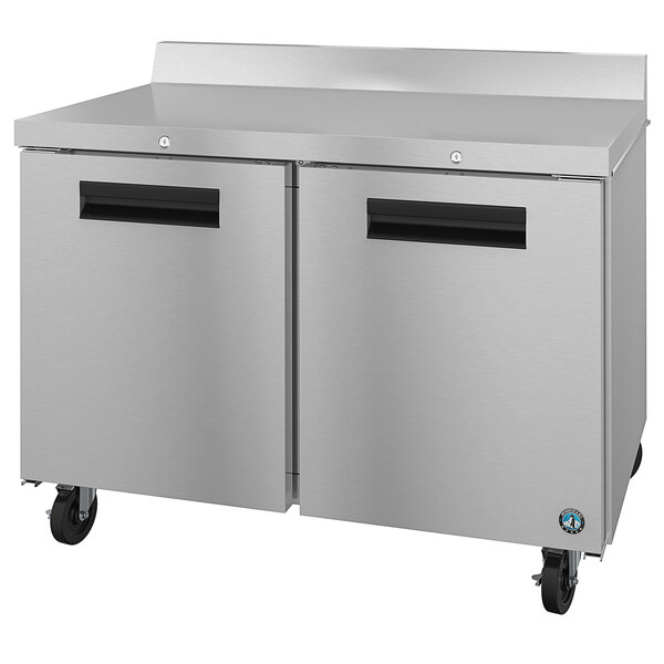 A stainless steel Hoshizaki worktop freezer on wheels with locks.