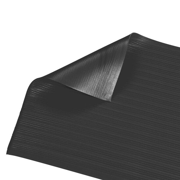 A black floor mat with a curled edge.