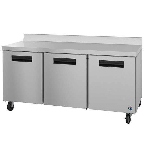 A stainless steel Hoshizaki worktop refrigerator with three black handles.
