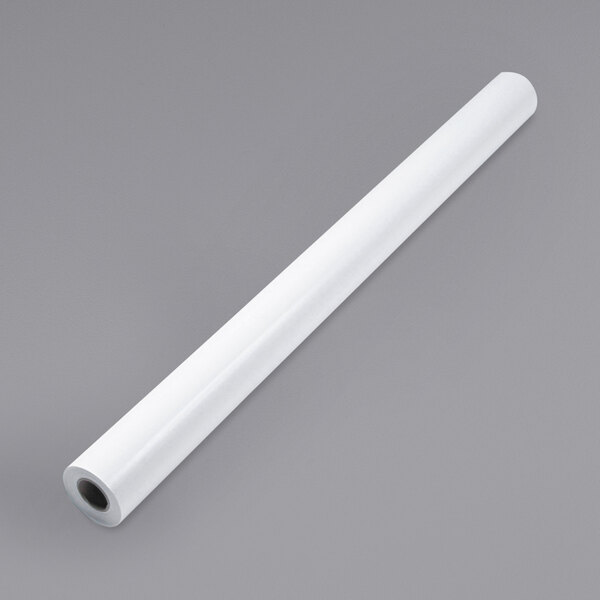 A roll of white paper on a gray surface.