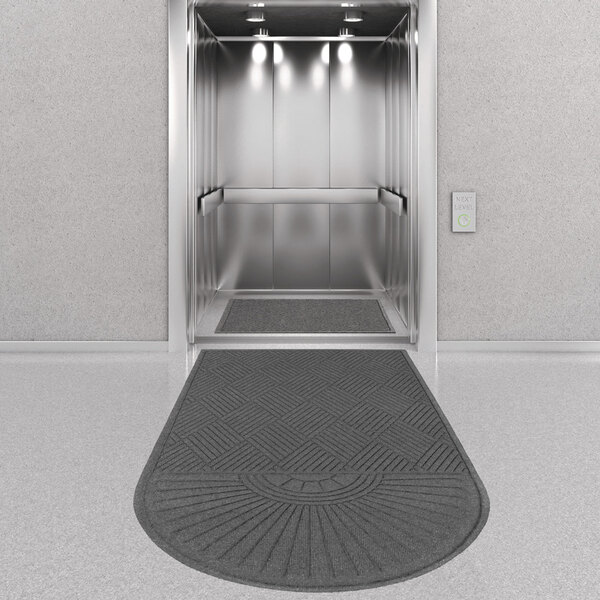 an elevator with lights and a rug