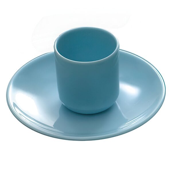 A blue cup and saucer on a blue jade oval melamine platter.