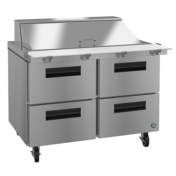 A stainless steel commercial refrigerated sandwich prep table with drawers.