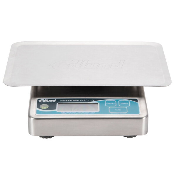 An Edlund digital portion scale on a white surface with writing on it.