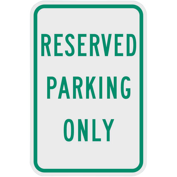 A white and green sign that says "Reserved Parking Only" in green text.