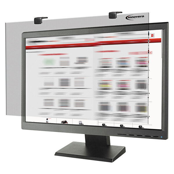 An Innovera privacy monitor filter on a computer screen showing a blurry newspaper.