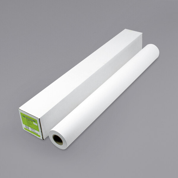 A roll of HP DesignJet coated white large format paper next to a white box.