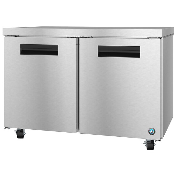 A stainless steel Hoshizaki undercounter refrigerator with black handles.