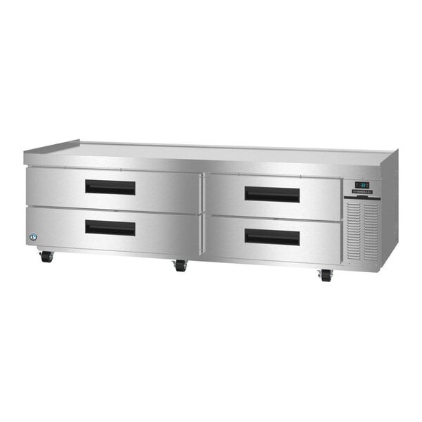 An 85-inch stainless steel refrigerated chef base with four drawers and caster wheels.