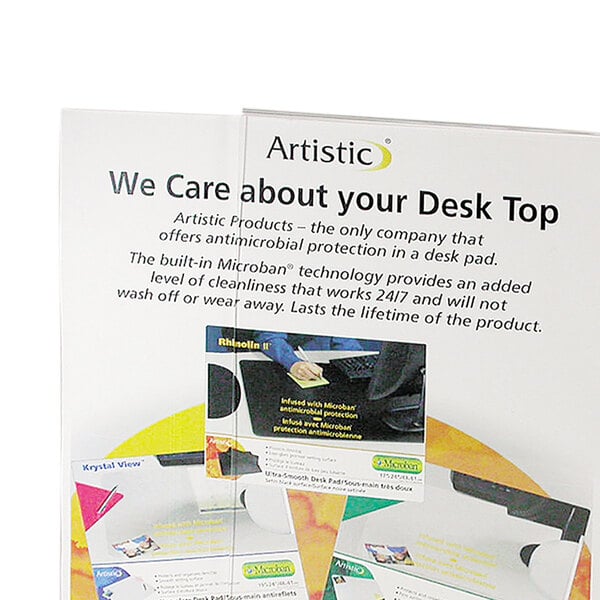 A white NuDell plastic sign holder on a desk with a sign inside.