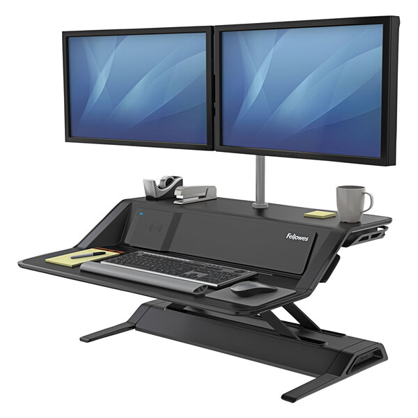 A Fellowes Lotus DX sit-stand workstation with two computer monitors on it.