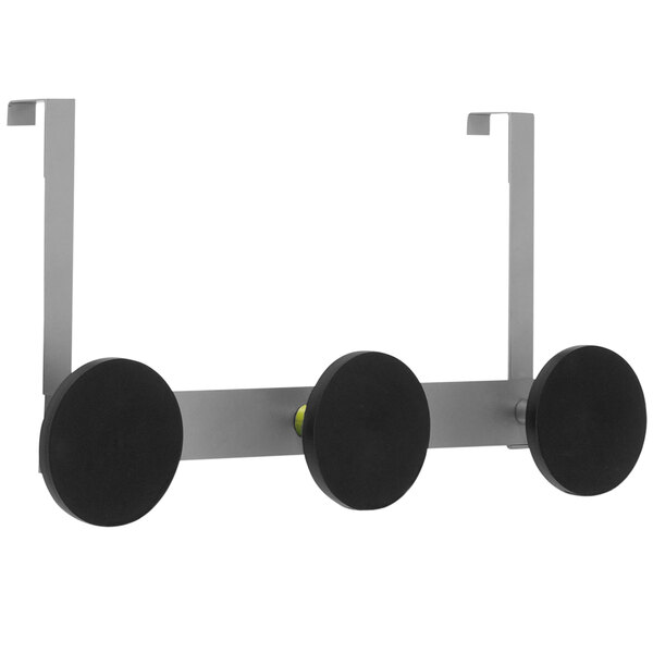 A metal rack with three black circles.