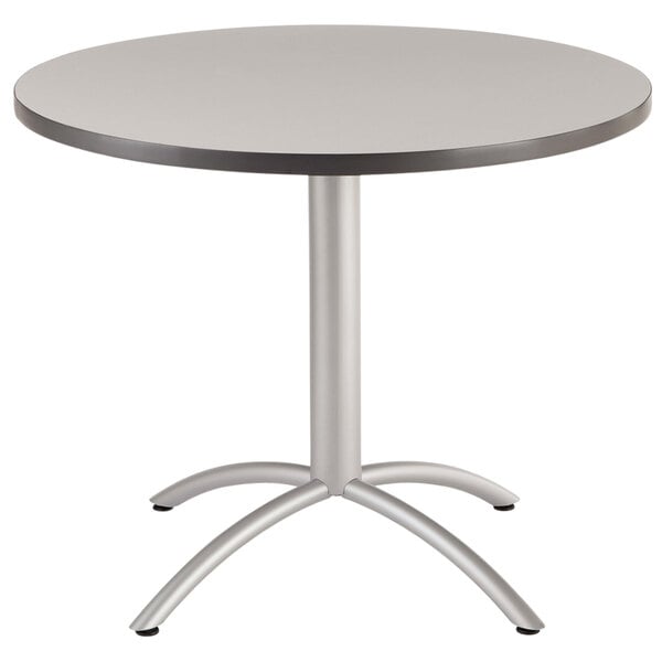 A gray Iceberg CafeWorks round table with a metal base.