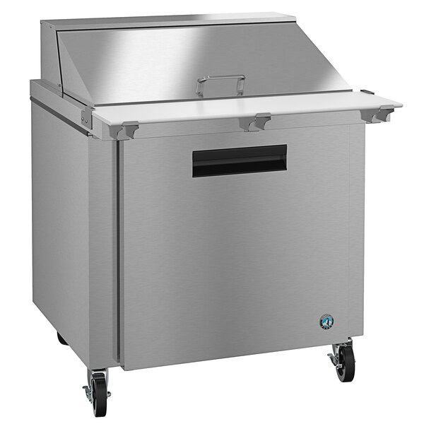 A Hoshizaki stainless steel refrigerated sandwich prep table with wheels.