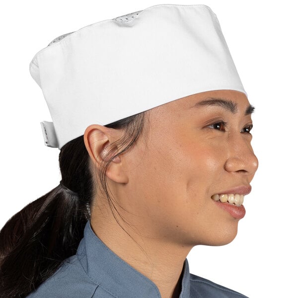 A woman wearing a white Uncommon Chef skull cap with mesh top.