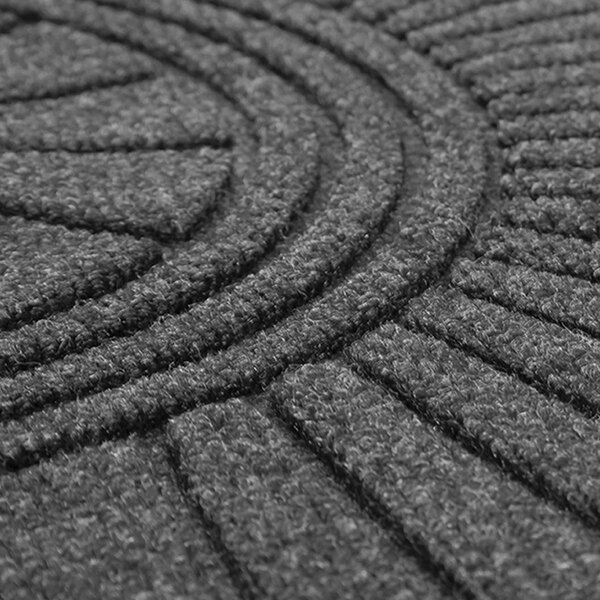 A close-up of a charcoal Guardian EcoGuard floor mat with a circular diamond design.