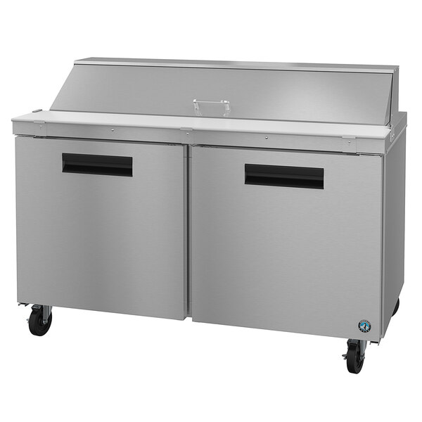 A stainless steel refrigerated counter with two doors.