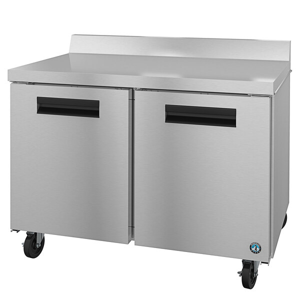 A Hoshizaki stainless steel worktop freezer with black handles.