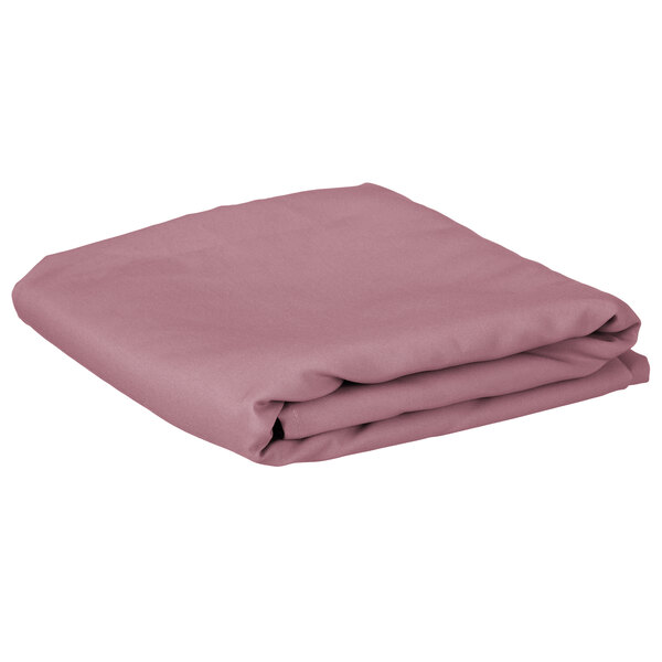 A folded pink table cover on a white background.