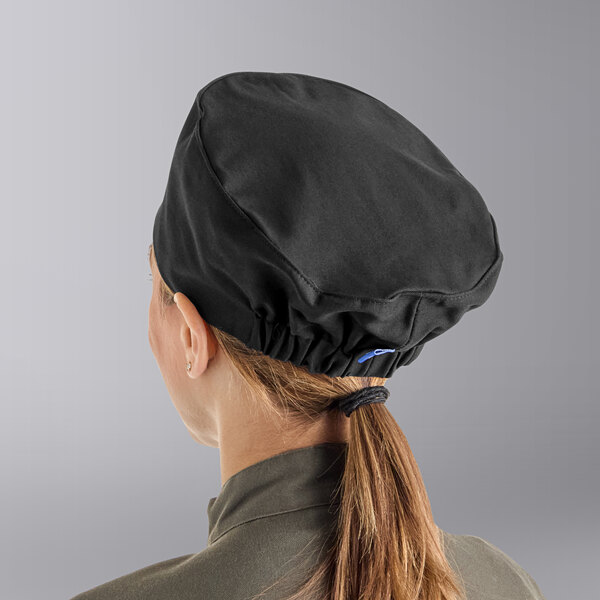 A woman wearing a black Uncommon Chef skull cap.