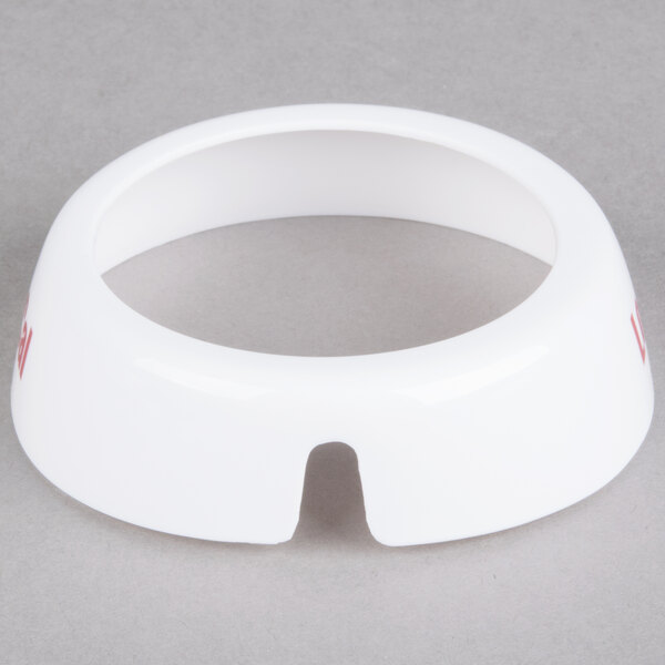 A white plastic Tablecraft salad dressing dispenser collar with maroon lettering.