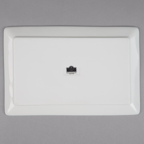 A white rectangular porcelain plate with a logo on it.
