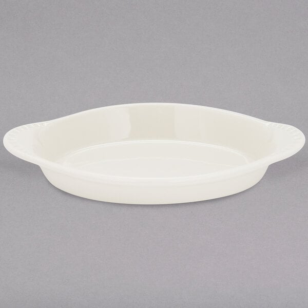 A white oval Tuxton Welsh Rarebit dish.