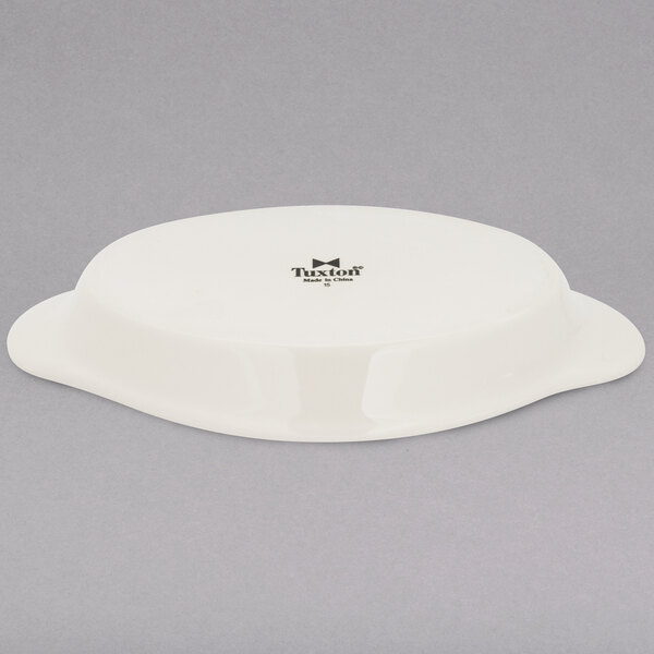 A white Tuxton oval dish with a lid.