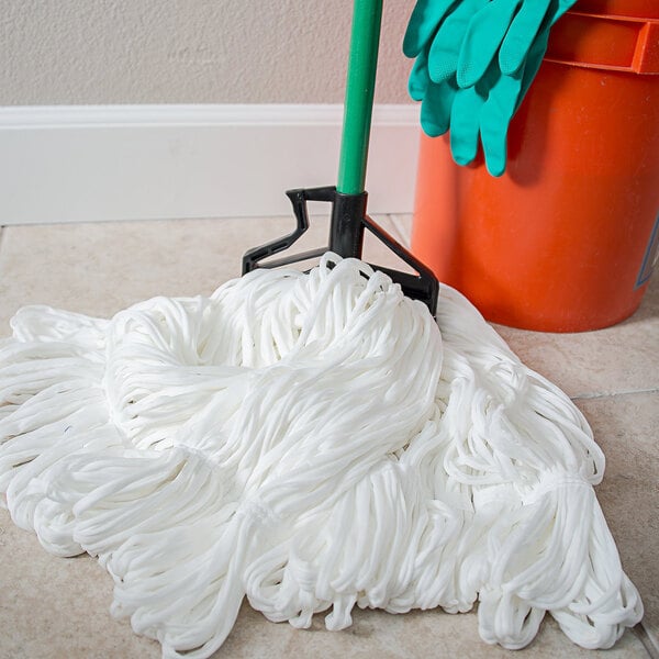 A Carlisle green fiberglass mop handle with a plastic head.