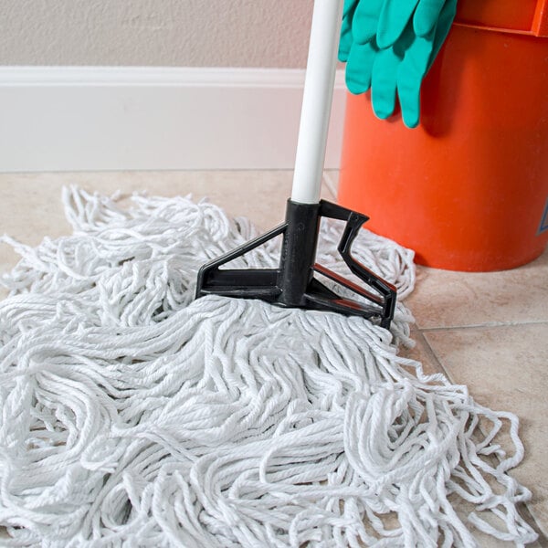 A Carlisle white fiberglass mop handle with a plastic head.