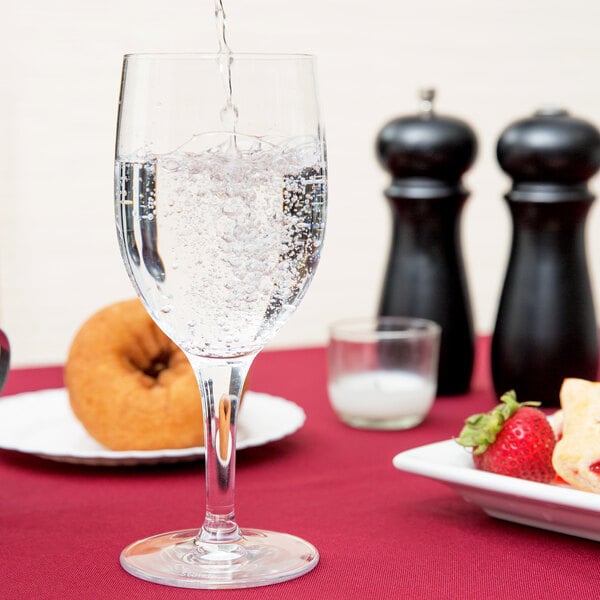 A close-up of a Stolzle all-purpose goblet filled with water on a table.