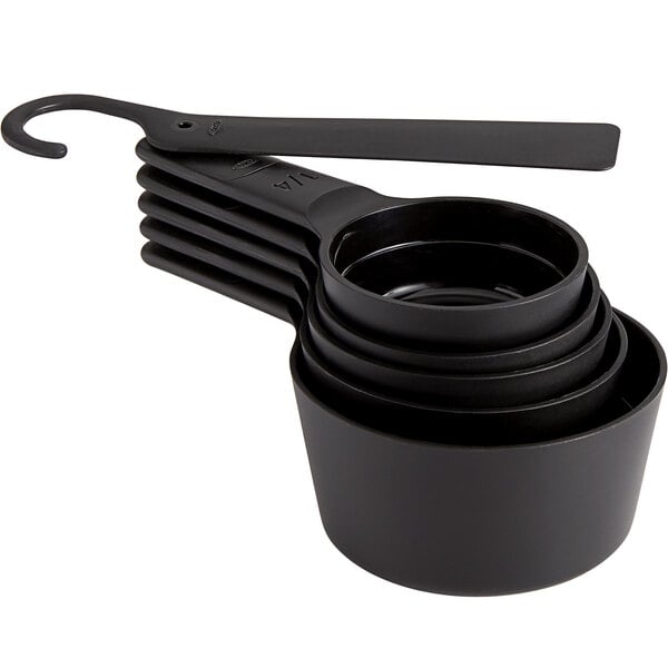 A close-up of a black OXO measuring cup with a handle.