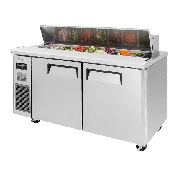 A Turbo Air refrigerated sandwich prep table on a counter with food inside.