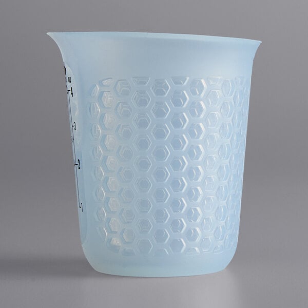 An OXO translucent blue plastic measuring cup with a handle.