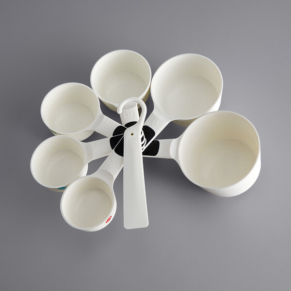 A white OXO measuring cup set with 7 pieces.