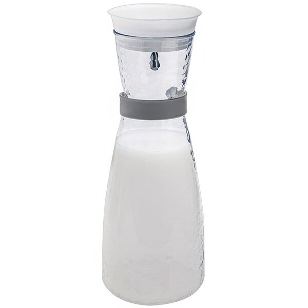 A white glass carafe with a label on it.