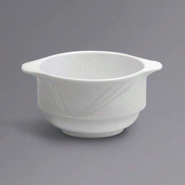 A close-up of a white Oneida Buffalo Arcadia bouillon bowl with handles.