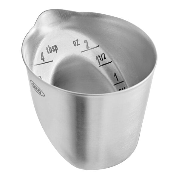 A stainless steel angled measuring cup or jigger with measurement markings for ounces and tablespoons.