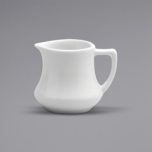 A white Oneida Buffalo porcelain creamer with a handle.