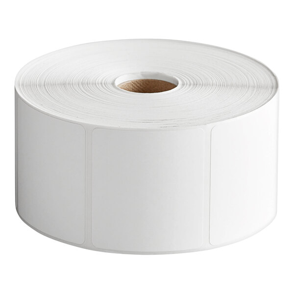 A large roll of blank white adhesive labels with rounded corners and a cardboard core.