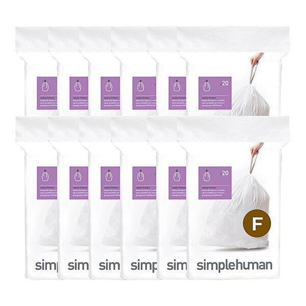 A person holding a simplehuman white plastic trash can liner.