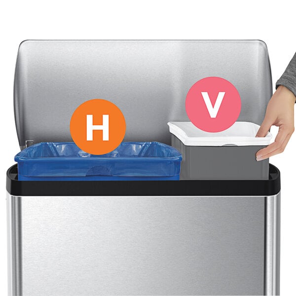 A person's hand putting a blue and white trash can liner into a trash can.