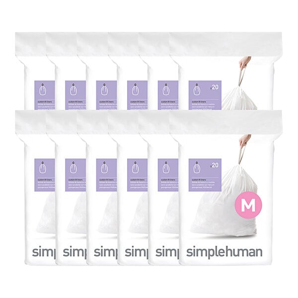 A group of white plastic packages of simplehuman trash can liners.