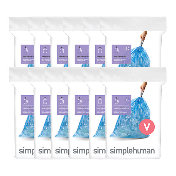 A hand holding a blue simplehuman custom fit recycling liner.