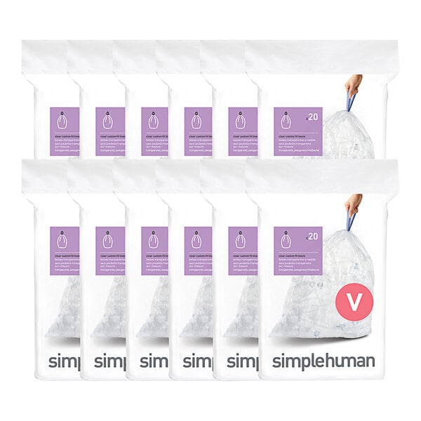 A hand holding a simplehuman clear plastic trash can liner.