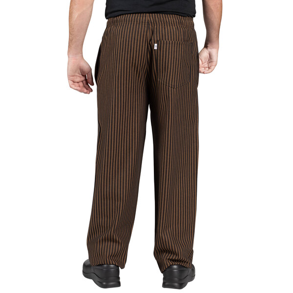 A person wearing Uncommon Chef black and copper stripe chef pants.