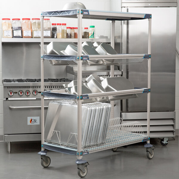 A Metro Metromax iQ metal drying rack with trays on it.